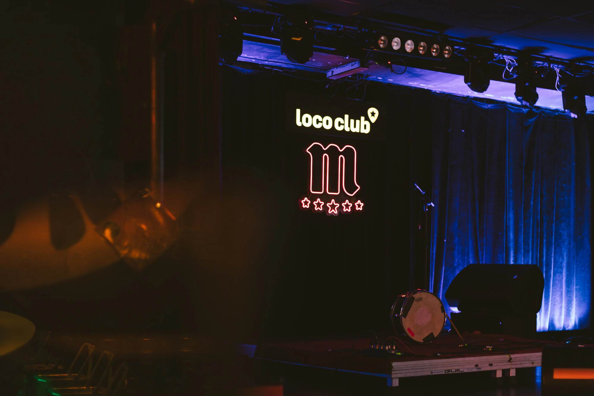 The Loco Club stage, lit in blue, with the club logo on the backdrop